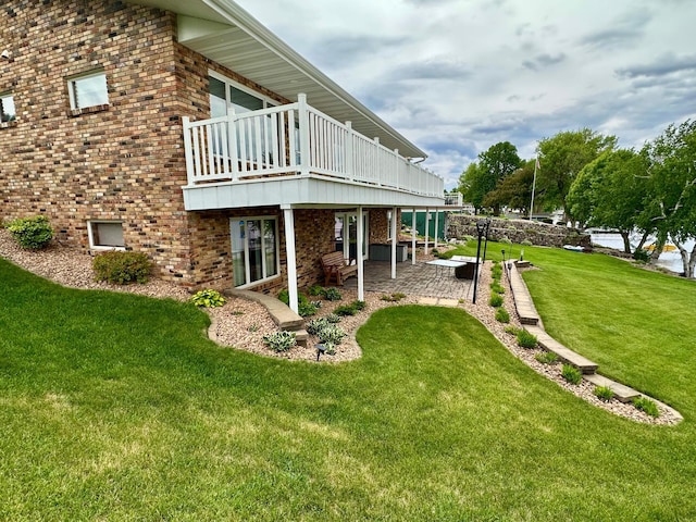 1606 Shore Dr, Worthington, MN 56187 - view of green lawn featuring a patio area and a wooden deck