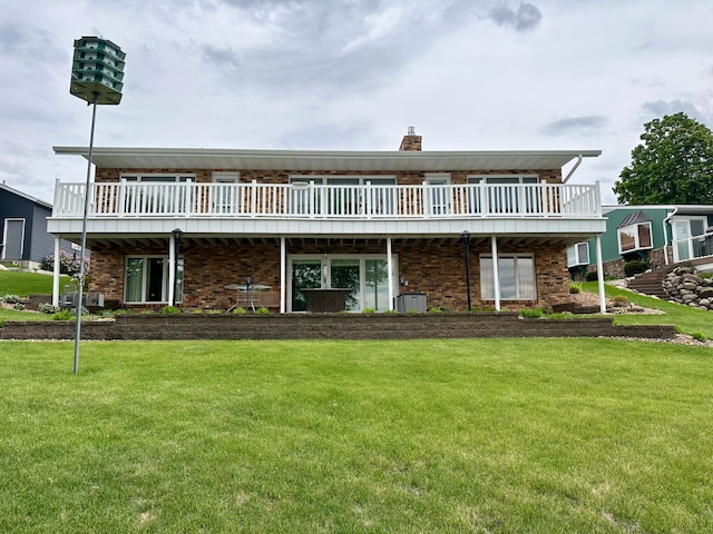 1606 Shore Dr, Worthington, MN 56187 - back of house with a yard, brick siding, and a chimney