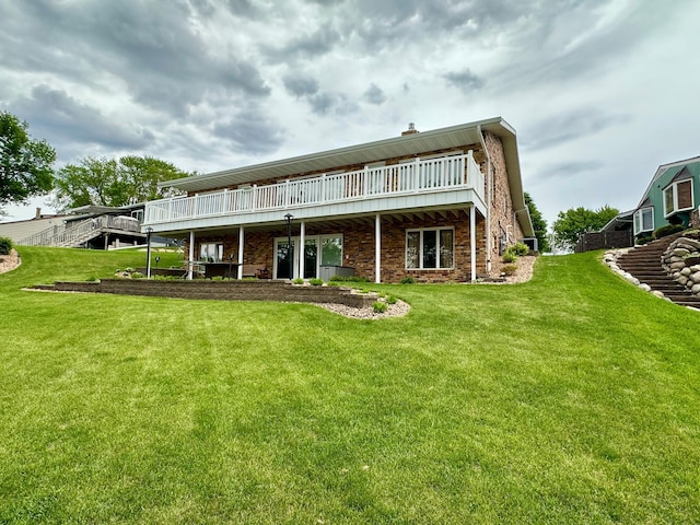 1606 Shore Dr, Worthington, MN 56187 - back of house with a yard, a wooden deck, and brick siding