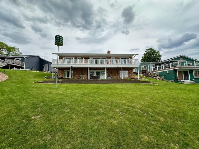 1606 Shore Dr, Worthington, MN 56187 - rear view of property featuring a lawn, a wooden deck, and a chimney