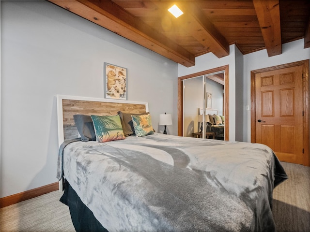 carpeted bedroom featuring beamed ceiling, wooden ceiling, and a closet