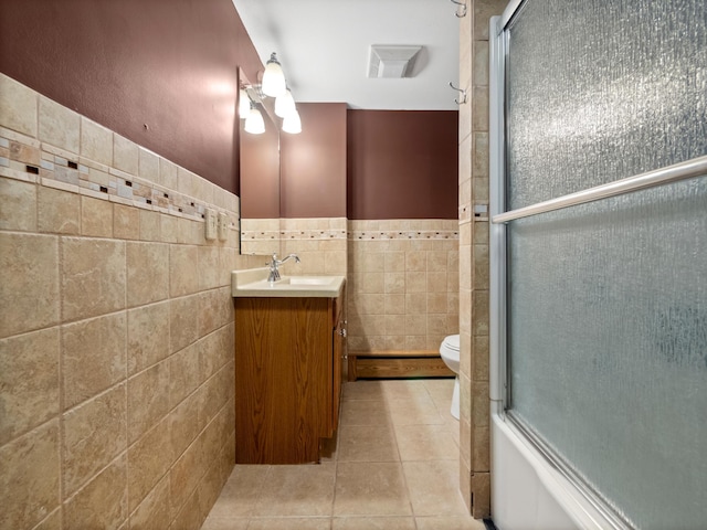 full bathroom featuring tile walls, vanity, enclosed tub / shower combo, and toilet