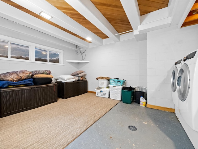 interior space with washer and dryer and concrete block wall