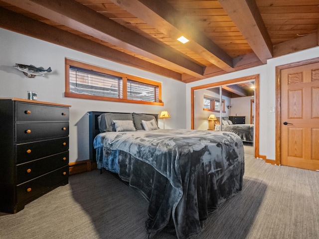 carpeted bedroom featuring beamed ceiling, wood ceiling, and a closet