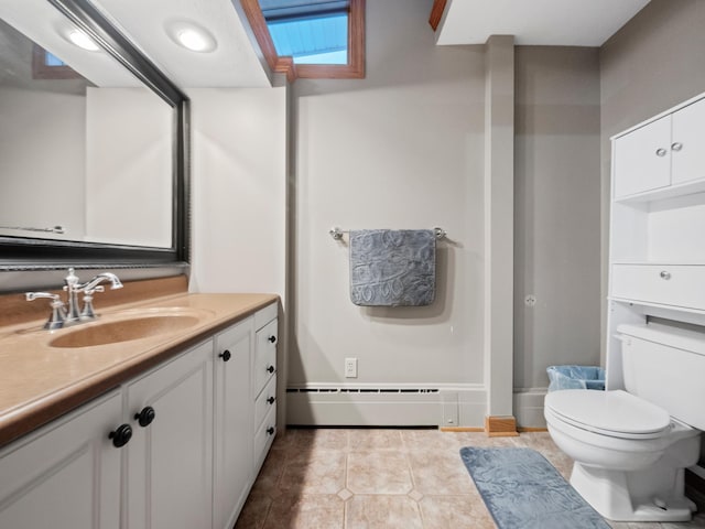 bathroom with a baseboard heating unit, vanity, toilet, and tile patterned floors