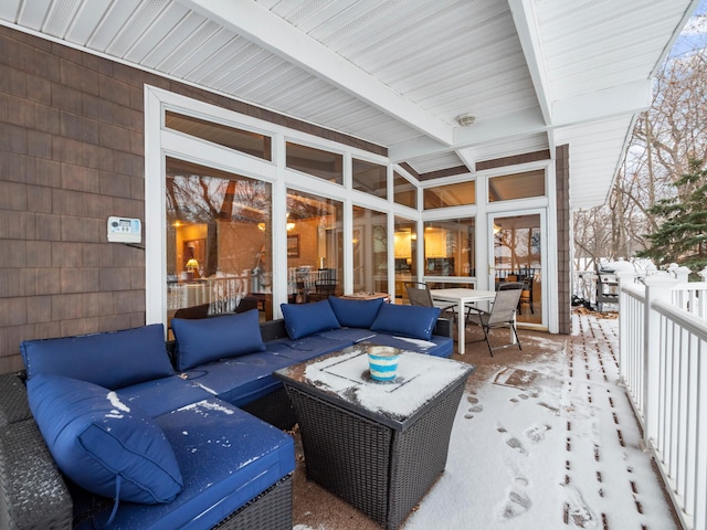 snow covered patio with an outdoor hangout area