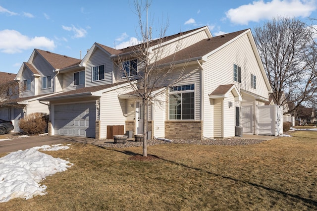 view of front facade with a garage and a front lawn