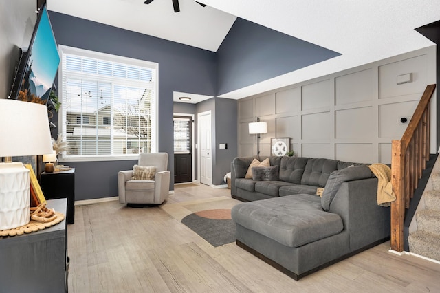 living room featuring ceiling fan and light hardwood / wood-style flooring