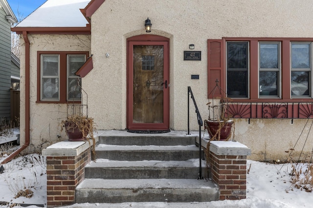 view of snow covered property entrance