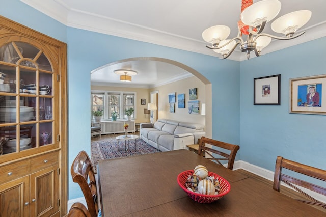 dining area with a chandelier and ornamental molding