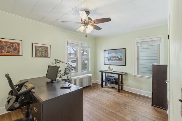 office featuring ceiling fan, ornamental molding, hardwood / wood-style flooring, and radiator heating unit