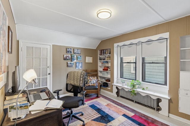 home office with vaulted ceiling and radiator heating unit