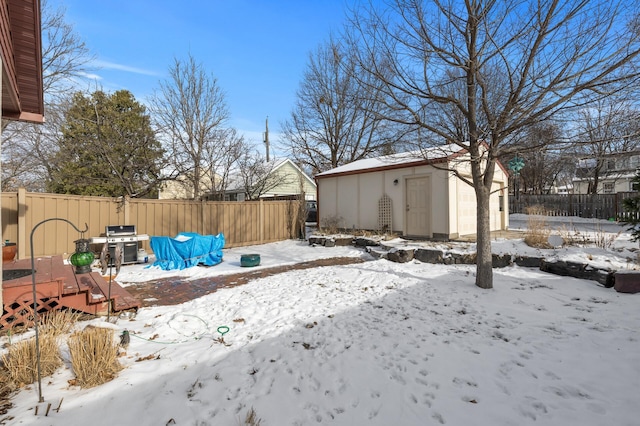 snowy yard with a storage unit