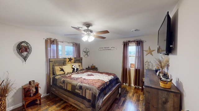 bedroom with ceiling fan and dark hardwood / wood-style flooring