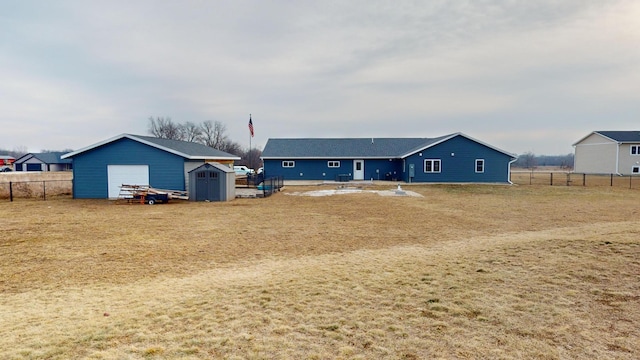 back of house with a storage unit