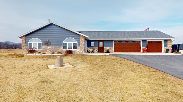 ranch-style house featuring a garage and a front yard