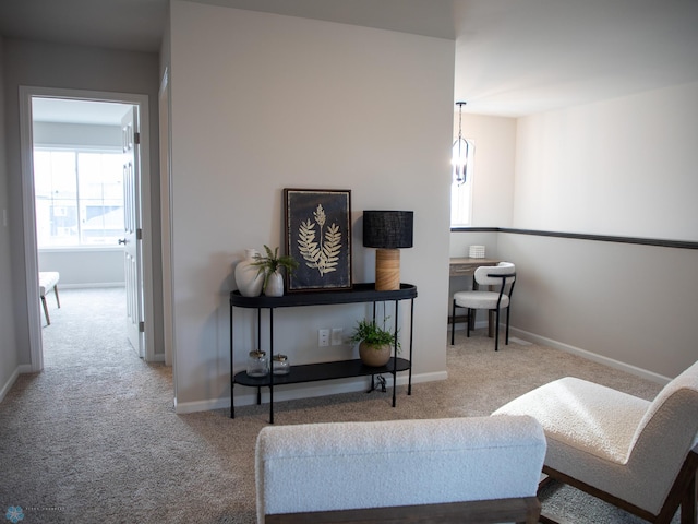 sitting room with a notable chandelier and light colored carpet