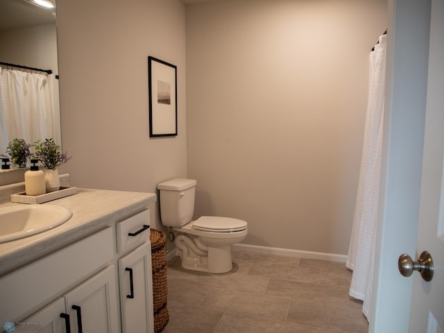 bathroom featuring toilet and vanity