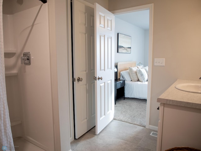 bathroom featuring curtained shower and vanity