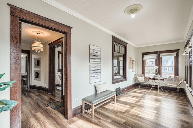 723 Lowry Ave NE, Minneapolis, MN 55418 - sitting room featuring a chandelier, wood finished floors, baseboards, and crown molding