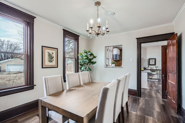723 Lowry Ave NE, Minneapolis, MN 55418 - dining room featuring a chandelier, dark wood finished floors, crown molding, and baseboards