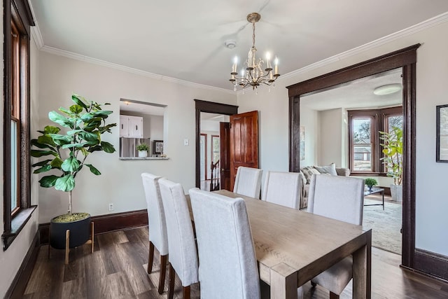 723 Lowry Ave NE, Minneapolis, MN 55418 - dining room featuring a chandelier, baseboards, dark wood-style floors, and crown molding