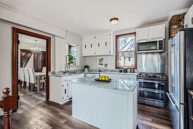 723 Lowry Ave NE, Minneapolis, MN 55418 - kitchen with appliances with stainless steel finishes, a chandelier, white cabinetry, dark wood finished floors, and plenty of natural light
