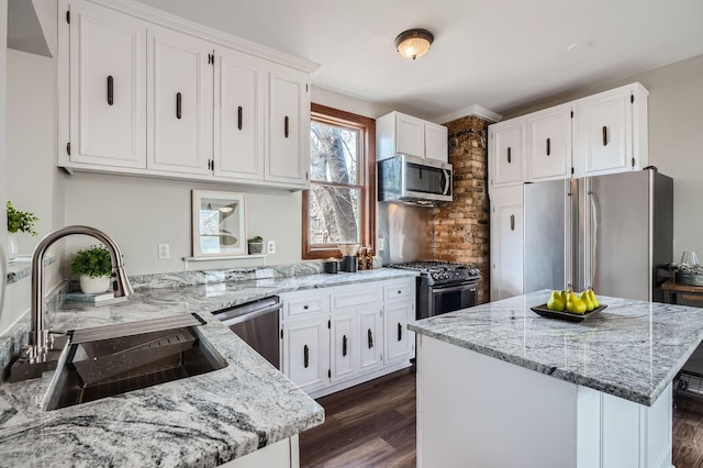 723 Lowry Ave NE, Minneapolis, MN 55418 - kitchen featuring appliances with stainless steel finishes, a sink, light stone counters, and white cabinetry