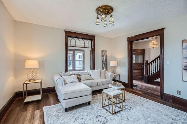 723 Lowry Ave NE, Minneapolis, MN 55418 - living room featuring baseboards, stairway, wood finished floors, a chandelier, and a textured ceiling