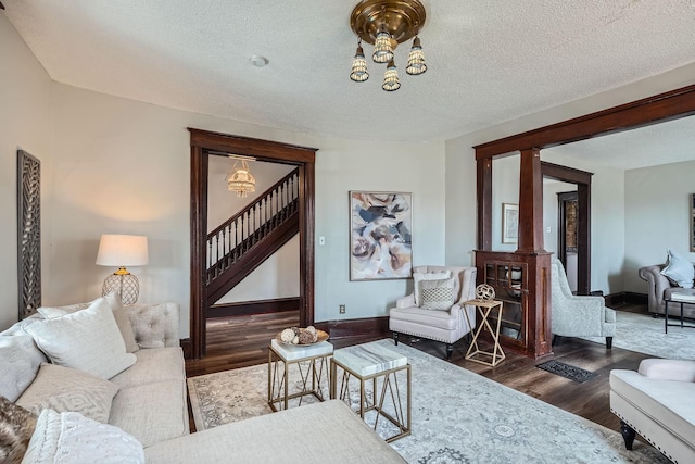 723 Lowry Ave NE, Minneapolis, MN 55418 - living area with stairs, dark wood-style floors, a chandelier, baseboards, and a textured ceiling