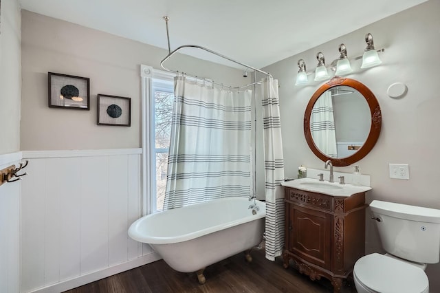 723 Lowry Ave NE, Minneapolis, MN 55418 - bathroom featuring a soaking tub, wood finished floors, vanity, toilet, and a shower with shower curtain