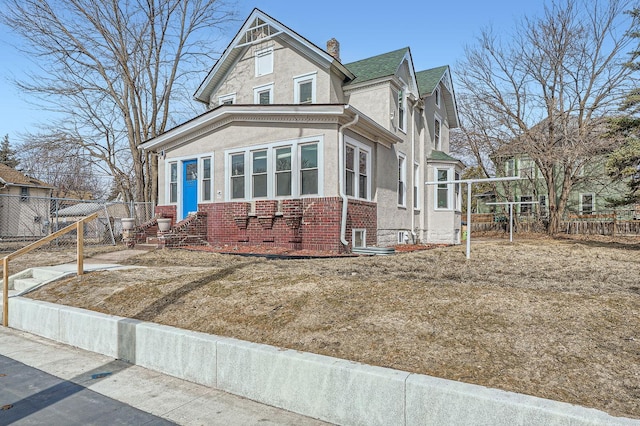 723 Lowry Ave NE, Minneapolis, MN 55418 - victorian home with stucco siding, brick siding, and a chimney