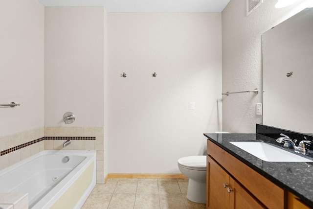 bathroom featuring vanity, tile patterned floors, a tub, and toilet