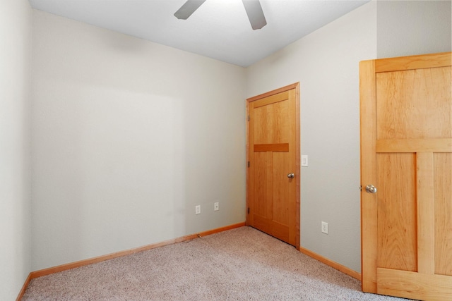 spare room featuring ceiling fan and light colored carpet