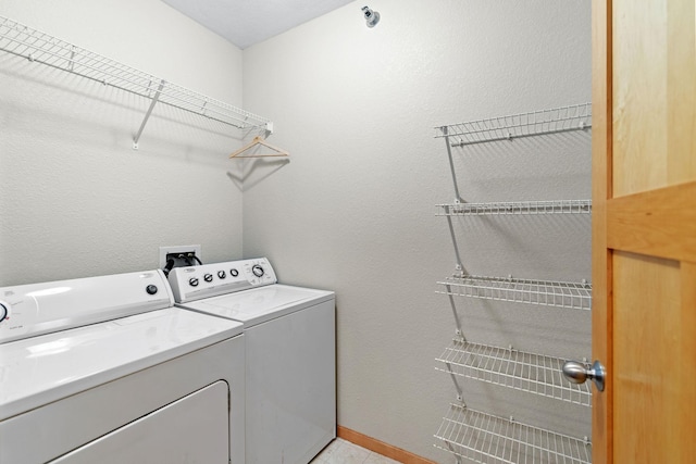 washroom with washer and dryer