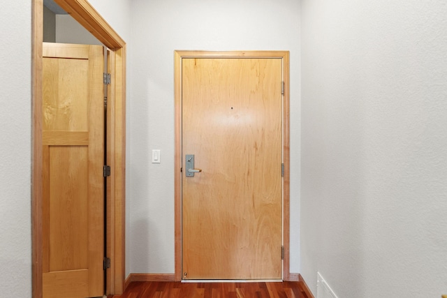 entryway with hardwood / wood-style floors