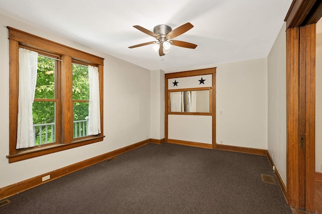 451 Everett St N, Stillwater, MN 55082 - spare room featuring dark colored carpet, a ceiling fan, and baseboards