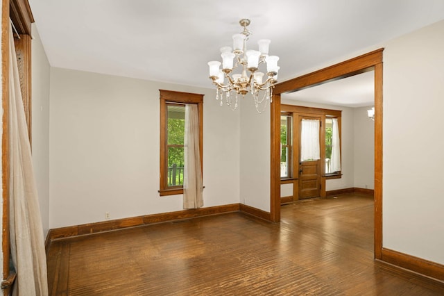 451 Everett St N, Stillwater, MN 55082 - spare room featuring baseboards, a chandelier, hardwood / wood-style floors, and plenty of natural light