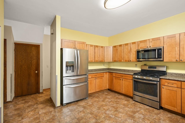 451 Everett St N, Stillwater, MN 55082 - kitchen with appliances with stainless steel finishes, dark countertops, and stone finish flooring