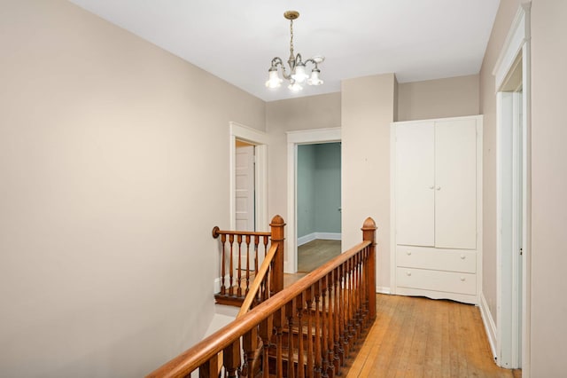 451 Everett St N, Stillwater, MN 55082 - corridor featuring an upstairs landing, light wood-type flooring, a chandelier, and baseboards