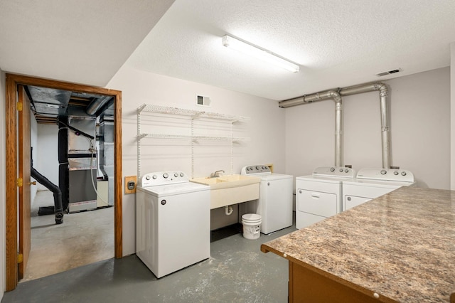 451 Everett St N, Stillwater, MN 55082 - washroom with washing machine and clothes dryer, a textured ceiling, a sink, and heating unit