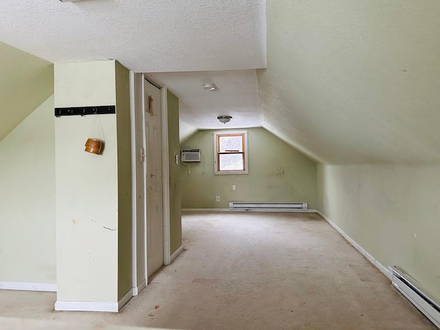 additional living space with baseboard heating, a wall mounted air conditioner, and a textured ceiling