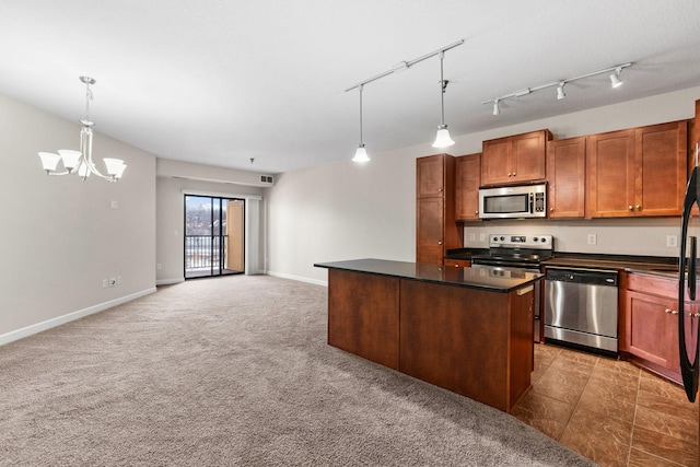 kitchen featuring appliances with stainless steel finishes, pendant lighting, a center island, light colored carpet, and an inviting chandelier