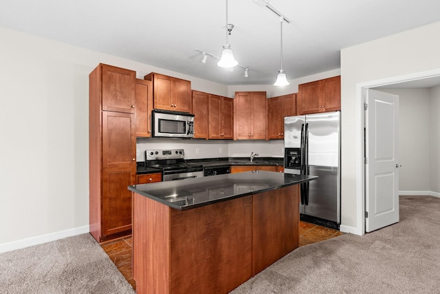 kitchen featuring pendant lighting, sink, appliances with stainless steel finishes, a center island, and dark carpet