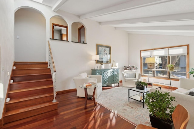 living room featuring vaulted ceiling with beams and dark hardwood / wood-style flooring