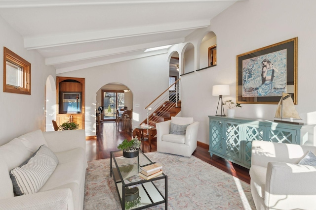 living room with wood-type flooring and vaulted ceiling with beams