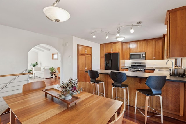 dining area featuring wood-type flooring and sink