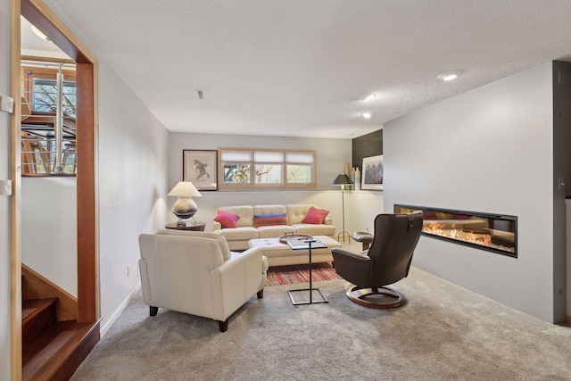 carpeted living room featuring a textured ceiling