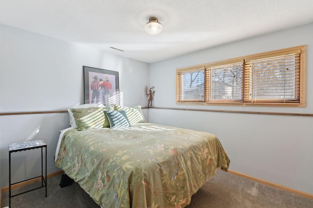 carpeted bedroom featuring a textured ceiling