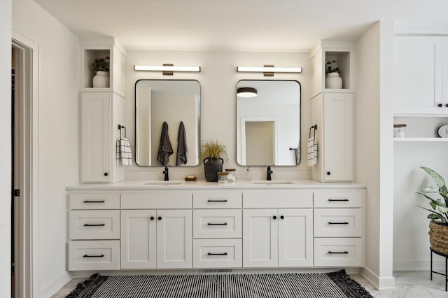 bathroom with a textured ceiling and vanity